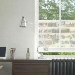 Closeup view of a study desk with laptop and lamp