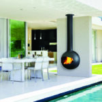 Set table on patio by pool of modern house