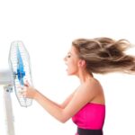 Girl with fan over white
