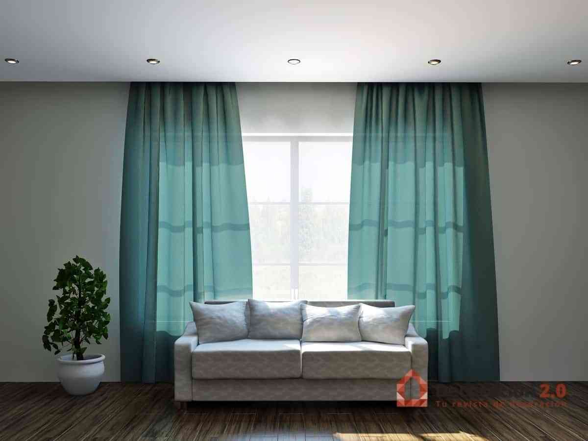 Cortinas verdes en salón con sofá blanco