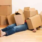Man covered in cardboard boxes – moving concept