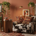 A bohemian eclectic bedroom corner with a cowhide print accent chair next to a dark oak side table,