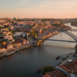 Aerial view of the historic city of Porto Portugal at golden hour, showing the colorful old town, th