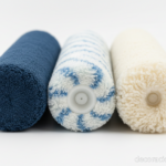Close-up detail shot of three different paint roller covers side by side on a clean white surface, s