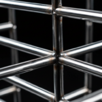 Close-up macro detail of welded chrome metal rods forming an abstract structure of a designer magazi