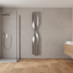 Contemporary bathroom interior with a vertical sculptural designer radiator in brushed steel mounted