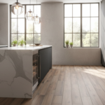 Elegant kitchen peninsula with porcelain stoneware floor in wood-look finish, soft pendant lighting,