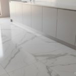 Large format porcelain floor tiles with marble pattern in a spacious modern kitchen, diagonal layout