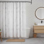 Stylish small bathroom with a white shower curtain featuring subtle botanical leaf pattern, black ma