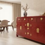 Elegant Chinese sideboard with deep red lacquer finish and golden brass hardware, placed in a sophis
