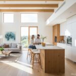 Modern open-plan kitchen connected to living room, bright natural light, kitchen island with bar sto