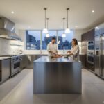Modern luxury kitchen with stainless steel appliances, a man and woman preparing food together at a