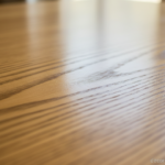 Close-up detail of clear pine wood grain texture on a polished furniture surface, showing smooth kno