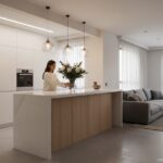 Beautiful kitchen island serving as room divider between kitchen and living room, pass-through count