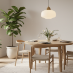 An elegant dining room with a round wooden table set for four people, warm pendant light hanging abo