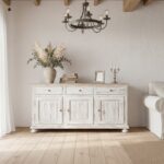 Beautiful white washed vintage wooden cabinet with distressed patina finish in a bright rustic livin