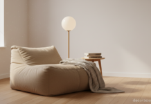 Puf decorativo beige en salón nórdico junto a lámpara de pie