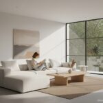 A serene minimalist living room with clean lines, low-profile white sofa, light wood coffee table, a