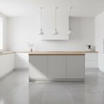 Modern kitchen interior with beautiful large format porcelain tile flooring in light grey tones, ope