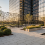 Contemporary corporate office garden courtyard with an elegant black-lacquered metal lace fence as p